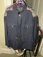 Front view of navy military jacket on hanger