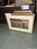 Full view of framed print leaning against furniture