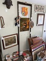 Full view of wall rack with pegs and surrounding items