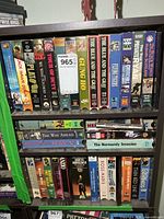 Overall view of two shelves of war-related VHS tapes