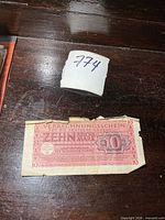 Front of 10 Reichsmark note showing denomination and damage