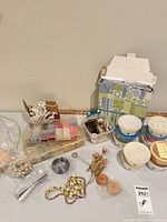 Overall view of assorted beads, wire, findings and storage containers on table