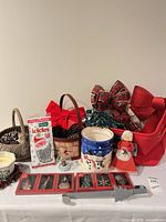 Full lot showing cookie jar, baskets, bows, lights, tinsel pack, ornaments, candle, doll, metal hanger