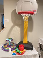 Full lot showing basketball hoop, spinner and sand toys