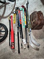 Group of sticks and bat laid on floor