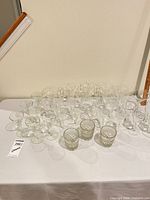 Group shot of all stemmed glasses and tumblers on table