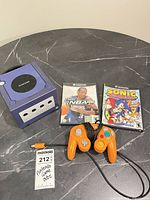 Front view of console, controller, and two game cases