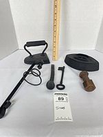 Overall lot view with sad iron assembled, trivet-style base and accessories laid out