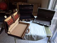 Three briefcases opened to show interiors and hardware