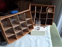 two divided cartons showing stacked clear glasses and single loose glass in front