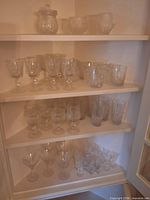 Full cabinet view showing all shelves of crystal pieces