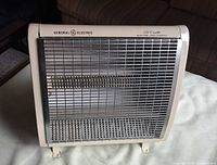 Front view of General Electric space heater showing grille, logo and wattage marking