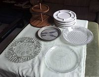 Full lot showing all plates and wooden stand