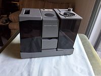 Front view showing overall humidifier with dual tanks and central housing