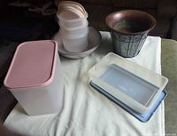 All items grouped: plastic containers, aluminum bowls, metal plant holder