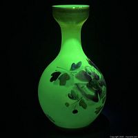 vase glowing green under UV showing uranium content