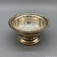 Oblique view of bowl showing beaded rim and pedestal base