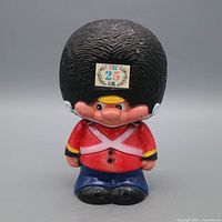 Front view of British Guard coin bank showing colors and condition
