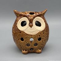 Front view showing owl face, ventilation holes, glazed finish