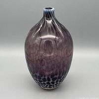 Front view of hand-blown plum and blue spotted glass vase