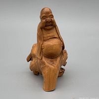 Front view showing carved Buddha details and integrated base