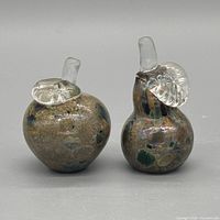 Front view of both glass fruit figurines