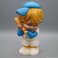 Front view of plaster baseball player coin bank