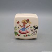 Cube-shaped ceramic money box with nursery rhyme girl and lamb decal, coin slot on top, cream glaze