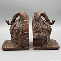 Front view of both carved wooden elephant bookends standing upright
