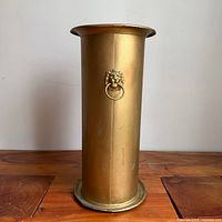 Front view showing lion head ring mount on brass umbrella stand