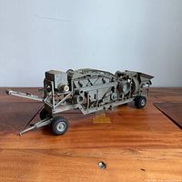 Left side view showing full crusher model with tow bar and wheels