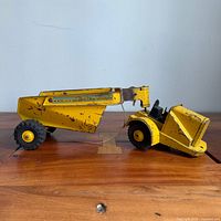 Full side profile of yellow Marx Lumar Rocker Dump truck showing overall form