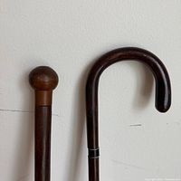 Two wooden canes showing knob and crook handles
