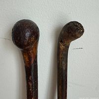 Close-up tops of both canes showing handle shapes