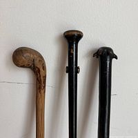 tops of the three canes showing handle styles