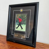 Angled front view of complete framed Tiger Woods piece displaying photo, matting, plaque and frame condition