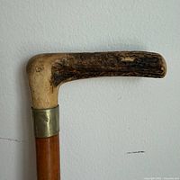 Close-up of bone handle and brass collar