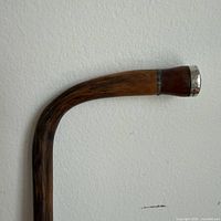 Curved wooden handle with silver tip