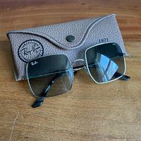 Sunglasses front view with case showing logo and 1971 imprint