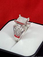 Front view of ring showing pavé diamond square head and split shank