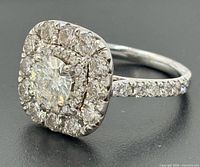 Angle view of diamond double halo ring showing central stone, halos, and pavé band