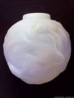 Front view showing opalescent glass vase with carp relief