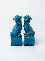 Front view of both turquoise Foo Dog statues on plinths