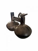 Front oblique view showing twin chambers, stirrup handle and bird effigy