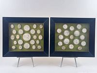 Two frames showing multiple round wax intaglios on green velvet