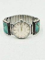 Front view of Omega Seamaster watch with turquoise inlay sterling tips and expansion band