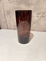 Full view of amber cylindrical glass vase with etched rose motif