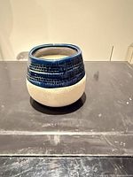 Side view of blue and white ceramic scented candle