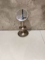 Front view of brushed nickel standing mirror with two trays