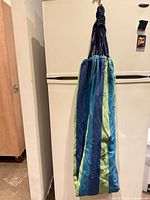 Hammock chair folded showing striped fabric and cords